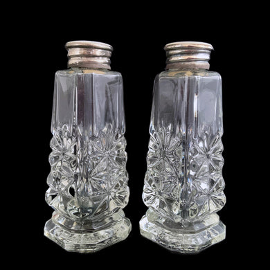 Enhance your tablescape with these sparkling vintage fine cut crystal tower-shaped footed salt and peppers shakers topped with silver lids inlaid with mother-of-pearl....stunning! The crystal is in excellent condition, free from chips. The sterling silver lids show wear. Measures 1 3/8 x 3 1/4 inches