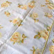 Load image into Gallery viewer, Lovely vintage Truprest yellow Rose Romance poly cotton queen size flat bed sheet featuring roses in shades of yellow with pale blue and green leaves finished with yellow trim at the band. Crafted by Texmade, Canada, 1973-1977. Create a restful slumber with these beautifully designed and well-made linens or use for crafting or garment making.

In good used vintage condition, no tears/stains.

Measures 88 x 108 inches
