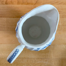 Load image into Gallery viewer, Vintage Tulip Time blue transferware ceramic creamer on white ground with swirl border features an intricate scene depicting a Dutch village, complete with windmills, cottages, and boats. Crafted by Johnson Brothers, England, 1962 - 1977. A lovely addition to your tablescape!

In excellent condition, no chips.

Measures 4 3/8 inches

Capacity 10 ounces
