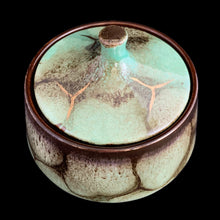 Load image into Gallery viewer, Vintage art pottery covered candy dish, glazed in turquoise, brown and gold. Crafted by Carstens Tonnieshof, West Germany, 1960s. In good used vintage condition, minor chip to the interior bowl, not visible with the lid in place. Measures 5 1/4 x 4 5/8 inches
