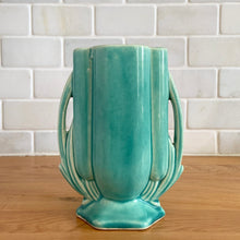 Load image into Gallery viewer, Vintage Art Deco turquoise vase 105 features a unique shape and double leaf decorative handles. Crafted by McCoy Pottery, 1940s. This rare piece is must for any art pottery collector! A lovely way to enhance your home&#39;s decor or give as a gift!

In excellent vintage condition, no chips/cracks/repairs. Typical age-related crazing, manufacturer&#39;s glaze pops. Unmarked.

Measures 4 x 2 1/8 x 5 1/2 inches
