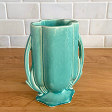Load image into Gallery viewer, Vintage Art Deco turquoise vase 105 features a unique shape and double leaf decorative handles. Crafted by McCoy Pottery, 1940s. This rare piece is must for any art pottery collector! A lovely way to enhance your home&#39;s decor or give as a gift!

In excellent vintage condition, no chips/cracks/repairs. Typical age-related crazing, manufacturer&#39;s glaze pops. Unmarked.

Measures 4 x 2 1/8 x 5 1/2 inches
