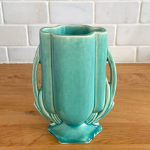 Load image into Gallery viewer, Vintage Art Deco turquoise vase 105 features a unique shape and double leaf decorative handles. Crafted by McCoy Pottery, 1940s. This rare piece is must for any art pottery collector! A lovely way to enhance your home&#39;s decor or give as a gift!

In excellent vintage condition, no chips/cracks/repairs. Typical age-related crazing, manufacturer&#39;s glaze pops. Unmarked.

Measures 4 x 2 1/8 x 5 1/2 inches
