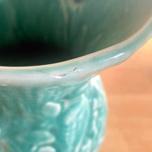 Load image into Gallery viewer, Vintage Art Deco gloss turquoise Peacock handled vase with birds and botanicals. Crafted by McCoy Pottery, 1948. This rare piece is must for any McCoy art pottery collector!

In as found vintage condition, repaired chipped at the rim, chip at the room and crazing commensurate with age. Maker&#39;s mark.

Measures 4 5/8 x 8 1/8 inches
