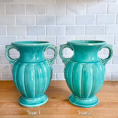 Beautiful vintage Art Deco turquoise green urn-shaped vase features decorative handles and a vertically ribbed body. Crafted by McCoy Pottery, 1950. This vase is must for any art pottery collector. A lovely way to enhance your home's decor or to give as a gift!

In excellent vintage condition, no chips/cracks/repairs. Typical manufacturer's glaze misses/pops. Maker's mark on the bottom.

Measures 7 x 9 1/4 inches (incl. handles)