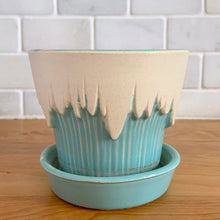 Load image into Gallery viewer, Vintage Art Deco turquoise icicle drip planter with attached underplate #511. Crafted by McCoy Pottery, early 1957. This rare piece is must for any art pottery collector! A lovely way to enhance your home's decor or give as a gift!

In excellent vintage condition, no chips/cracks/repairs. Typical age-related crazing, manufacturer's glaze pops. Maker's marks.

Measures 4 3/8 x 3 3/4 inches
