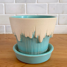 Load image into Gallery viewer, Vintage Art Deco turquoise icicle drip planter with attached underplate #511. Crafted by McCoy Pottery, early 1957. This rare piece is must for any art pottery collector! A lovely way to enhance your home's decor or give as a gift!

In excellent vintage condition, no chips/cracks/repairs. Typical age-related crazing, manufacturer's glaze pops. Maker's marks.

Measures 4 3/8 x 3 3/4 inches
