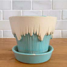 Load image into Gallery viewer, Vintage Art Deco turquoise icicle drip planter with attached underplate #511. Crafted by McCoy Pottery, early 1957. This rare piece is must for any art pottery collector! A lovely way to enhance your home's decor or give as a gift!

In excellent vintage condition, no chips/cracks/repairs. Typical age-related crazing, manufacturer's glaze pops. Maker's marks.

Measures 4 3/8 x 3 3/4 inches
