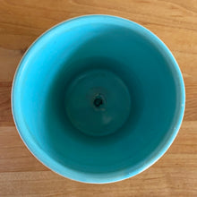 Load image into Gallery viewer, Vintage Art Deco turquoise icicle drip planter with attached underplate #511. Crafted by McCoy Pottery, early 1957. This rare piece is must for any art pottery collector! A lovely way to enhance your home's decor or give as a gift!

In excellent vintage condition, no chips/cracks/repairs. Typical age-related crazing, manufacturer's glaze pops. Maker's marks.

Measures 4 3/8 x 3 3/4 inches
