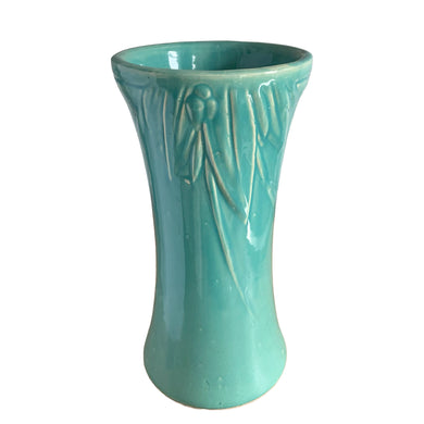 Beautiful vintage large turquoise trumpet vase with embossed leaves and berries at the rim. Crafted by McCoy Pottery, 1930s. This substantially sized vase is must for any art pottery collector!

In excellent vintage condition, no chips/cracks/repairs, manufacturers glaze pops, with age-related crazing. Unmarked.

Measures 7 1/4 x 14 inches