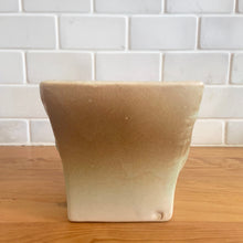 Load image into Gallery viewer, Vintage matte turquoise glazed lilies and leaves Rustic Line jardiniere planter. Crafted by McCoy Pottery, USA, 1945. This collectible planter is the perfect for succulents or decorative display and makes a lovely gift for an art pottery collector.

In excellent vintage condition, no chips,cracks or repairs, manufacturer&#39;s glaze pops. Unmarked.

Measures 4 5/8 x 4 1/8 x 4 inches
