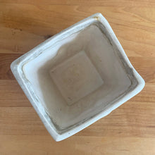 Load image into Gallery viewer, Vintage matte turquoise glazed lilies and leaves Rustic Line jardiniere planter. Crafted by McCoy Pottery, USA, 1945. This collectible planter is the perfect for succulents or decorative display and makes a lovely gift for an art pottery collector.

In excellent vintage condition, no chips,cracks or repairs, manufacturer&#39;s glaze pops. Unmarked.

Measures 4 5/8 x 4 1/8 x 4 inches
