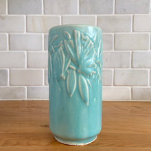 Load image into Gallery viewer, Vintage Art Deco matte turquoise Butterfly Line cylinder vase. Crafted by Nelson McCoy Pottery, 1940s. This rare piece is must for any art pottery collector! A lovely way to enhance your home&#39;s decor or give as a gift!

In excellent vintage condition, no chips/cracks/repairs. Typical age-related crazing, manufacturer&#39;s glaze pops. Maker&#39;s marks.

Measures 3 x 6 inches
