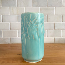 Load image into Gallery viewer, Vintage Art Deco matte turquoise Butterfly Line cylinder vase. Crafted by Nelson McCoy Pottery, 1940s. This rare piece is must for any art pottery collector! A lovely way to enhance your home&#39;s decor or give as a gift!

In excellent vintage condition, no chips/cracks/repairs. Typical age-related crazing, manufacturer&#39;s glaze pops. Maker&#39;s marks.

Measures 3 x 6 inches
