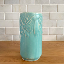 Load image into Gallery viewer, Vintage Art Deco matte turquoise Butterfly Line cylinder vase. Crafted by Nelson McCoy Pottery, 1940s. This rare piece is must for any art pottery collector! A lovely way to enhance your home&#39;s decor or give as a gift!

In excellent vintage condition, no chips/cracks/repairs. Typical age-related crazing, manufacturer&#39;s glaze pops. Maker&#39;s marks.

Measures 3 x 6 inches
