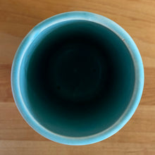 Load image into Gallery viewer, Vintage Art Deco matte turquoise Butterfly Line cylinder vase. Crafted by Nelson McCoy Pottery, 1940s. This rare piece is must for any art pottery collector! A lovely way to enhance your home&#39;s decor or give as a gift!

In excellent vintage condition, no chips/cracks/repairs. Typical age-related crazing, manufacturer&#39;s glaze pops. Maker&#39;s marks.

Measures 3 x 6 inches
