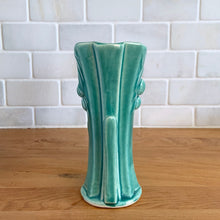 Load image into Gallery viewer, Vintage Art Deco turquoise split rim leaf and berries handled vase 104. Crafted by McCoy Pottery, 1948. This rare piece is must for any art pottery collector! A lovely way to enhance your home&#39;s decor or give as a gift!

In excellent vintage condition, no chips/cracks/repairs. Typical age-related crazing, manufacturer&#39;s glaze pops. Unmarked.

Measures 3 5/8 x 2 1/2 x 5 3/4 inches
