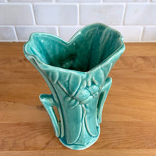 Load image into Gallery viewer, Vintage Art Deco turquoise split rim leaf and berries handled vase 104. Crafted by McCoy Pottery, 1948. This rare piece is must for any art pottery collector! A lovely way to enhance your home&#39;s decor or give as a gift!

In excellent vintage condition, no chips/cracks/repairs. Typical age-related crazing, manufacturer&#39;s glaze pops. Unmarked.

Measures 3 5/8 x 2 1/2 x 5 3/4 inches
