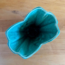 Load image into Gallery viewer, Vintage Art Deco turquoise split rim leaf and berries handled vase 104. Crafted by McCoy Pottery, 1948. This rare piece is must for any art pottery collector! A lovely way to enhance your home&#39;s decor or give as a gift!

In excellent vintage condition, no chips/cracks/repairs. Typical age-related crazing, manufacturer&#39;s glaze pops. Unmarked.

Measures 3 5/8 x 2 1/2 x 5 3/4 inches
