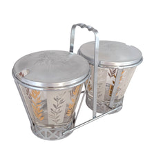 Load image into Gallery viewer, Vintage 2-part glass condiment server featuring alternating 22kt gold leaves and clear leaves on a white stripe and pinecone embossed aluminum lids in chrome caddy. Crafted by Dominion Glass, Canada, 1950s. Love the conical shape of the glass and the styling on the caddy....very mid-century modern and a great way to serve your favourite fixings.

In excellent condition, no chips.

Overall measures 7 3/4 x 4 x 5 1/2 inches

