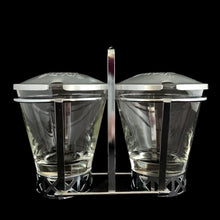 Load image into Gallery viewer, Vintage 2-part glass condiment server with rose embossed aluminum lids in a chrome caddy. Crafted by Dominion Glass, Canada, 1950s. Love the conical shape of the glass and the styling on the caddy....very mid-century modern and a great way to serve your favourite fixings.

In excellent condition, no chips.&nbsp;

Overall measures 7 x 3 1/2 x 5 3/8 inches
