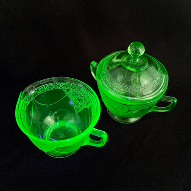 A stunning vintage depression era uranium pressed glass creamer and covered sugar in the 