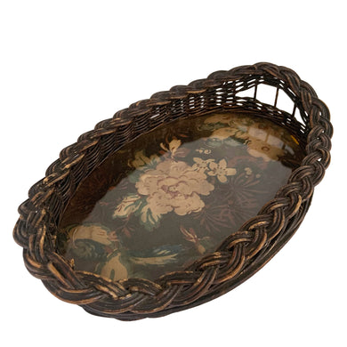 Pretty vintage Victorian natural wicker and wood oval tray featuring a braided rim and handles. The surface of the tray displays a fabric with florals and birds, under glass. A sturdy and beautifully made piece of craftsmanship that would look lovely on a vanity dresser, bedside or hall table.

In vintage condition with breaks in the wicker stems at one handle, see photos.

Measures 11 3/4 x 7 1/2 x 2 1/2 inches