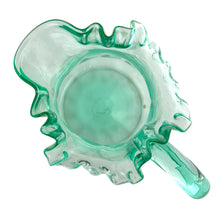 Load image into Gallery viewer, Antique Victorian era green uranium glass pitcher featuring gold, white and red enamel decoration with ruffle crimped rim and an applied handle. Glows beautifully under black light. Crafted by Fenton Art Glass, USA, early 20th century. A stunning piece to add to your glass collection.

In as found vintage condition with wear to the enamel. There is a stringer in the handle and a chip to the base of the handle itself.

Measures 5 3/4 x 8 x 10 inches
