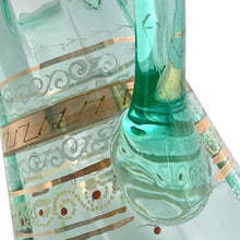 Load image into Gallery viewer, Antique Victorian era green uranium glass pitcher featuring gold, white and red enamel decoration with ruffle crimped rim and an applied handle. Glows beautifully under black light. Crafted by Fenton Art Glass, USA, early 20th century. A stunning piece to add to your glass collection.

In as found vintage condition with wear to the enamel. There is a stringer in the handle and a chip to the base of the handle itself.

Measures 5 3/4 x 8 x 10 inches

