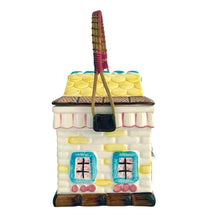 Load image into Gallery viewer, Adorable vintage mid-century colourfully hand painted figural village gingerbread house&nbsp;ceramic cookie jar with wrapped rattan handle. Crafted by Grantcrest, Japan, 1950s. A wonderful addition to your cookie jar collection and kitchen decor!  In great vintage condition, no chips, staining at the rim, crazing.  Measures 4 5/8 x 4 5/8 x 6 inches (9 inches tall with handle extended)
