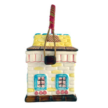 Load image into Gallery viewer, Adorable vintage mid-century colourfully hand painted figural village gingerbread house&nbsp;ceramic cookie jar with wrapped rattan handle. Crafted by Grantcrest, Japan, 1950s. A wonderful addition to your cookie jar collection and kitchen decor!  In great vintage condition, no chips, staining at the rim, crazing.  Measures 4 5/8 x 4 5/8 x 6 inches (9 inches tall with handle extended)
