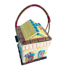 Load image into Gallery viewer, Adorable vintage mid-century colourfully hand painted figural village gingerbread house&nbsp;ceramic cookie jar with wrapped rattan handle. Crafted by Grantcrest, Japan, 1950s. A wonderful addition to your cookie jar collection and kitchen decor!  In great vintage condition, no chips, staining at the rim, crazing.  Measures 4 5/8 x 4 5/8 x 6 inches (9 inches tall with handle extended)
