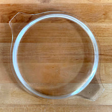Load image into Gallery viewer, Top-down overhead view of clear glass PYREX 474-C lid, showing round profile and tab handles
