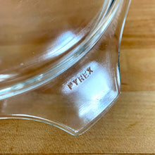 Load image into Gallery viewer, Close-up of clear glass PYREX 474-C lid handle tab showing embossed "PYREX" brand mark
