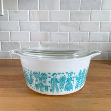Load image into Gallery viewer, Rear view of vintage turquoise PYREX Butterprint casserole dish with glass lid in place, showing full pattern detail
