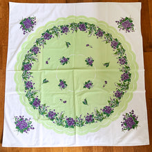 Load image into Gallery viewer, This vintage cotton tablecloth features a central scalloped apple green medallion bordered in white with beautiful purple violets on a white and green background. An elegant and traditional accent for any décor, made from high quality cotton.  In excellent condition.  Measures 50 x 47 1/2 inches
