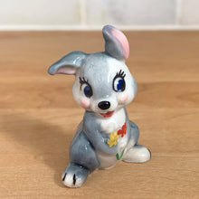 Load image into Gallery viewer, Delightful vintage Disney Thumper Rabbit porcelain figurine, Hat Box Series, Set 2. Wade Whimsies, England, 1950s/60s. Add this sweet figurine to your collection!

In excellent condition, no chips/cracks.

Measures 1 3/8 x 1 x 1 7/8 inches
