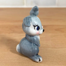Load image into Gallery viewer, Delightful vintage Disney Thumper Rabbit porcelain figurine, Hat Box Series, Set 2. Wade Whimsies, England, 1950s/60s. Add this sweet figurine to your collection!

In excellent condition, no chips/cracks.

Measures 1 3/8 x 1 x 1 7/8 inches
