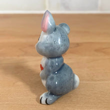 Load image into Gallery viewer, Delightful vintage Disney Thumper Rabbit porcelain figurine, Hat Box Series, Set 2. Wade Whimsies, England, 1950s/60s. Add this sweet figurine to your collection!

In excellent condition, no chips/cracks.

Measures 1 3/8 x 1 x 1 7/8 inches
