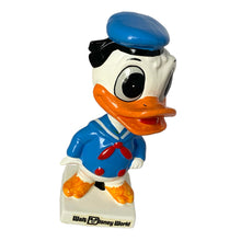 Load image into Gallery viewer, Vintage Walt Disney World Donald Duck paper mache bobble head nodder figurine. Crafted in Japan, 1960s (likely manufactured by Ardco). This beloved collectible along with its nodding head figurine adds a whimsical touch to any room or display. A must-have for any Disney enthusiast. This is a great opportunity for a Disney fan to own a piece of history and to add to their collection.
