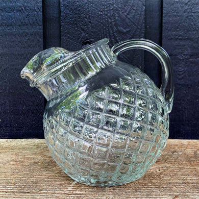 This vintage Waterford clear glass 42oz titled ball pitcher features a waffle pattern, ribbed collar and smooth handle. Anchor Hocking, USA, 1938 - 1944. A classic pitcher to serve your favourite beverage.

In excellent condition, no chips.

Measures 4 1/2 inches

Capacity 42 ounces