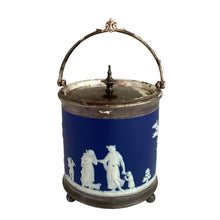 Load image into Gallery viewer, Antique Wedgwood cobalt blue Jasperware biscuit barrel with silver-plated mounts, neoclassical white relief figures, hinged lid with finial, and ball feet — front three-quarter view
