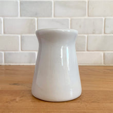 Load image into Gallery viewer, Vintage white ceramic creamer. Crafted by Sterling Vitrified China, USA. The charming sidekick to your morning coffee or tea!

In excellent condition, no chips/cracks.

Measures 2 1/2 x 3 1/4 inches
