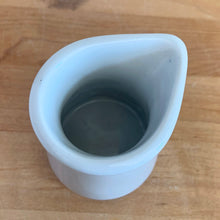 Load image into Gallery viewer, Vintage white ceramic creamer. Crafted by Sterling Vitrified China, USA. The charming sidekick to your morning coffee or tea!

In excellent condition, no chips/cracks.

Measures 2 1/2 x 3 1/4 inches
