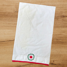 Load image into Gallery viewer, This single vintage white cotton pillowcase features a beautifully handcrafted crochet flower medallion and edge in deep pink, green and white. A gorgeous addition to your bed linens or repurpose for crafting! In excellent condition, free from tears or stains. Measures 32 x 20 inches
