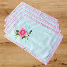 Load image into Gallery viewer, Set of 4 vintage white cotton placemats showcasing pink, blue, green and yellow floral applique and embroidery finished with a charming pink scalloped inset border. Ideal for adding charm to your table setting! In excellent condition. Free from tears/stains. Placemats measure 18 x 12 inches
