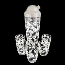 Load image into Gallery viewer, Vintage white Dogwood flower cocktail shaker with five matching glasses. Crafted by Hazel-Atlas Glass, USA, 1930s/40s. A wonderful Art Deco set to add to your barware collection!

In good used vintage condition, no chips or wear to the paint. Lid has age-related wear.

Shaker measures 3 1/4 x 10 1/4 inches, capacity 24 ounces

Glasses measures 2 3/8 x 3 3/4 inches, capacity 4 ounces
