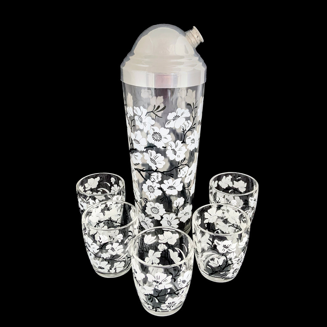 Vintage white Dogwood flower cocktail shaker with five matching glasses. Crafted by Hazel-Atlas Glass, USA, 1930s/40s. A wonderful Art Deco set to add to your barware collection!

In good used vintage condition, no chips or wear to the paint. Lid has age-related wear.

Shaker measures 3 1/4 x 10 1/4 inches, capacity 24 ounces

Glasses measures 2 3/8 x 3 3/4 inches, capacity 4 ounces