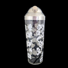 Load image into Gallery viewer, Vintage white Dogwood flower cocktail shaker with five matching glasses. Crafted by Hazel-Atlas Glass, USA, 1930s/40s. A wonderful Art Deco set to add to your barware collection!

In good used vintage condition, no chips or wear to the paint. Lid has age-related wear.

Shaker measures 3 1/4 x 10 1/4 inches, capacity 24 ounces

Glasses measures 2 3/8 x 3 3/4 inches, capacity 4 ounces
