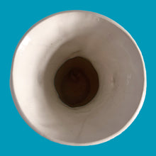 Load image into Gallery viewer, Beautiful vintage Bird of Paradise vase glazed in gloss white, features embossed bird and botanicals. Crafted by McCoy Pottery, 1940s. This vase is must for any art pottery collector!

In vintage condition, no repairs, chip on the foot. There is crazing present and one of the lines penetrates both sides at the rim, and appears stable. Maker&#39;s mark on the bottom.

Measures 4 7/8 x 3 3/4 x 8 inches
